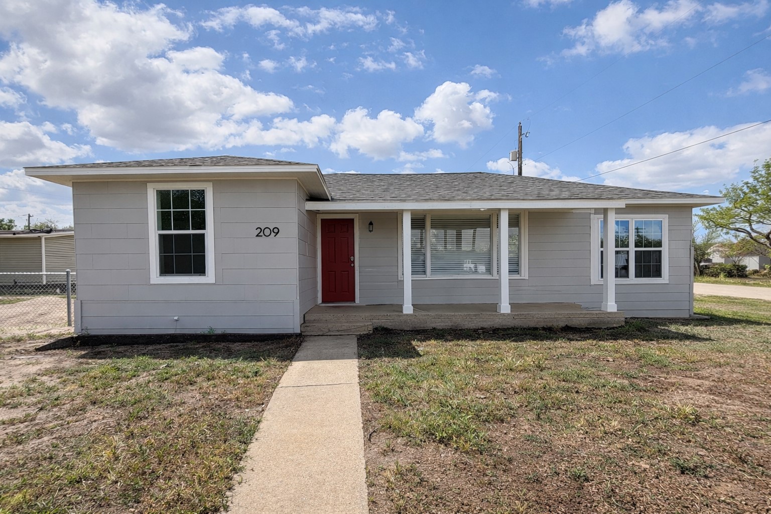 209 West Alfred Street El Campo, TX 77437 - Photo 1 of 15 a front view of a house with garden