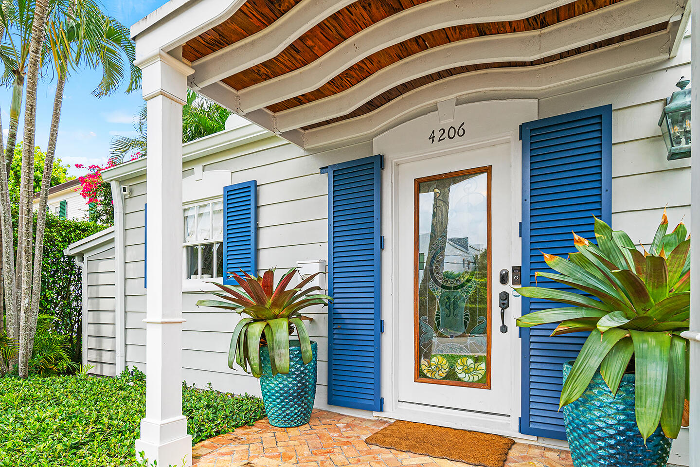 4206 Washington Road West Palm Beach, FL 33405 - Photo 2 of 50 a front view of a house with a garden