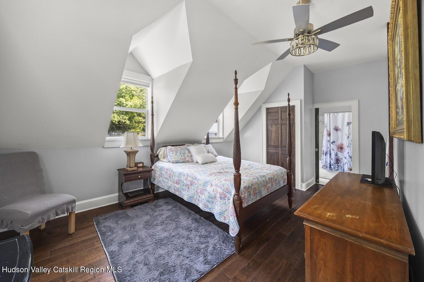 4 Greely Road Craryville, NY 12521 - Photo 15 of 37 a bedroom with a bed a chandelier and a dresser
