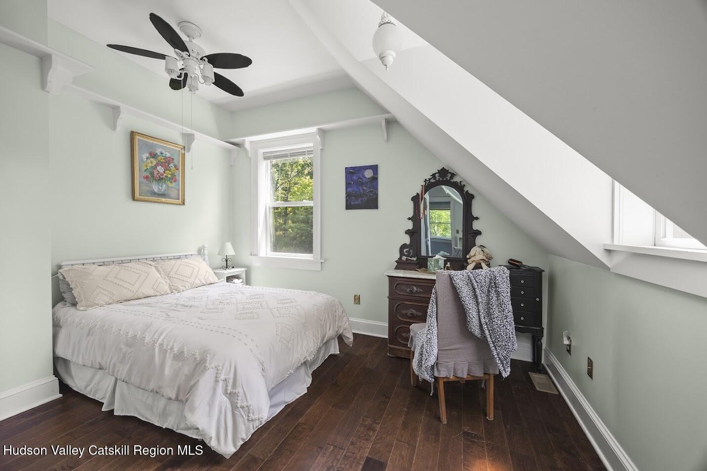 4 Greely Road Craryville, NY 12521 - Photo 18 of 37 a bedroom with a bed a dresser and wooden floor