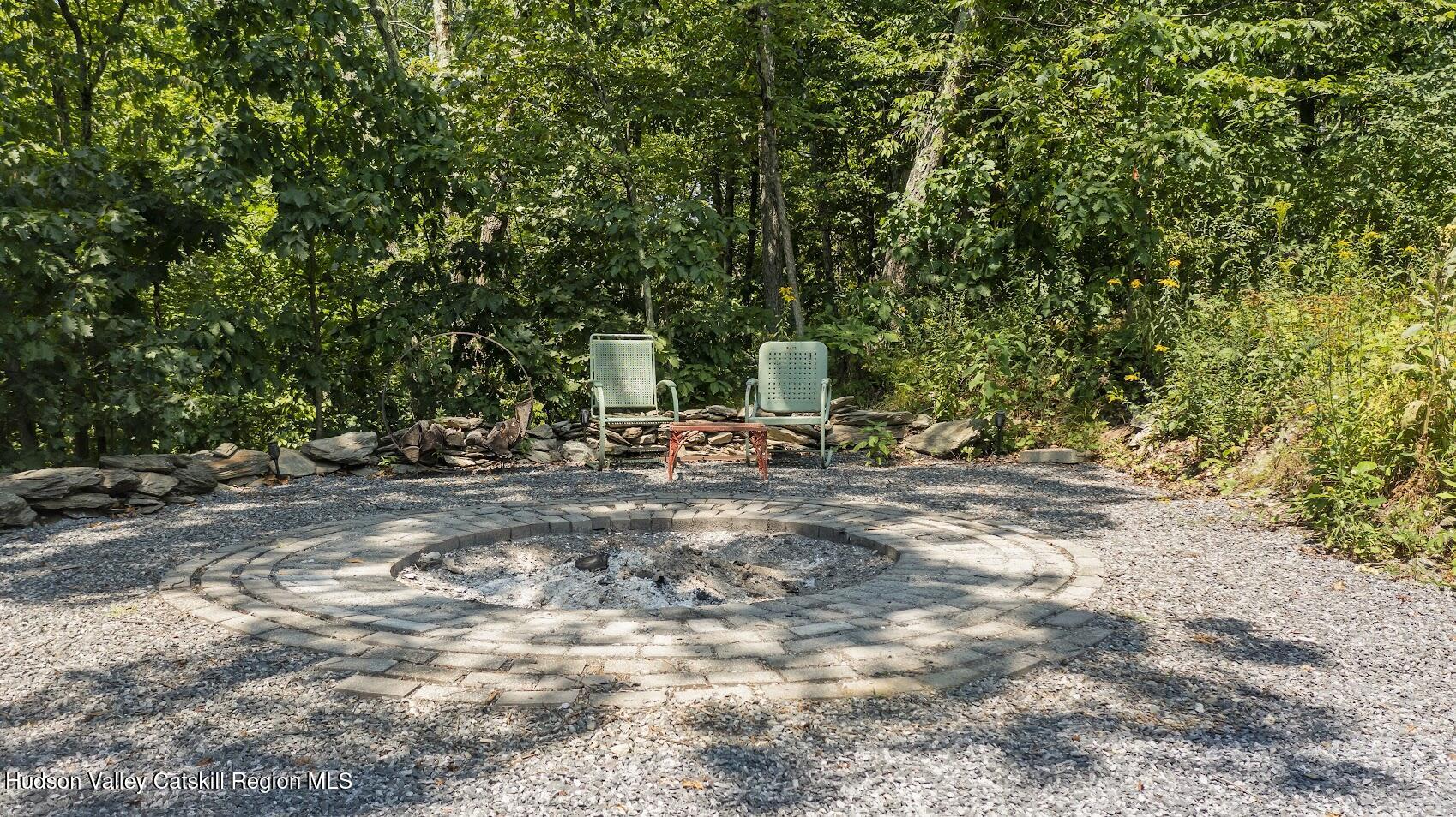 4 Greely Road Craryville, NY 12521 - Photo 33 of 37 a backyard of a house with table and chairs