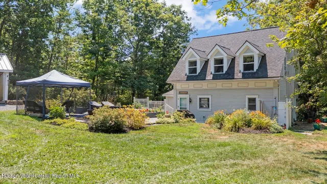 a front view of house with yard and trees