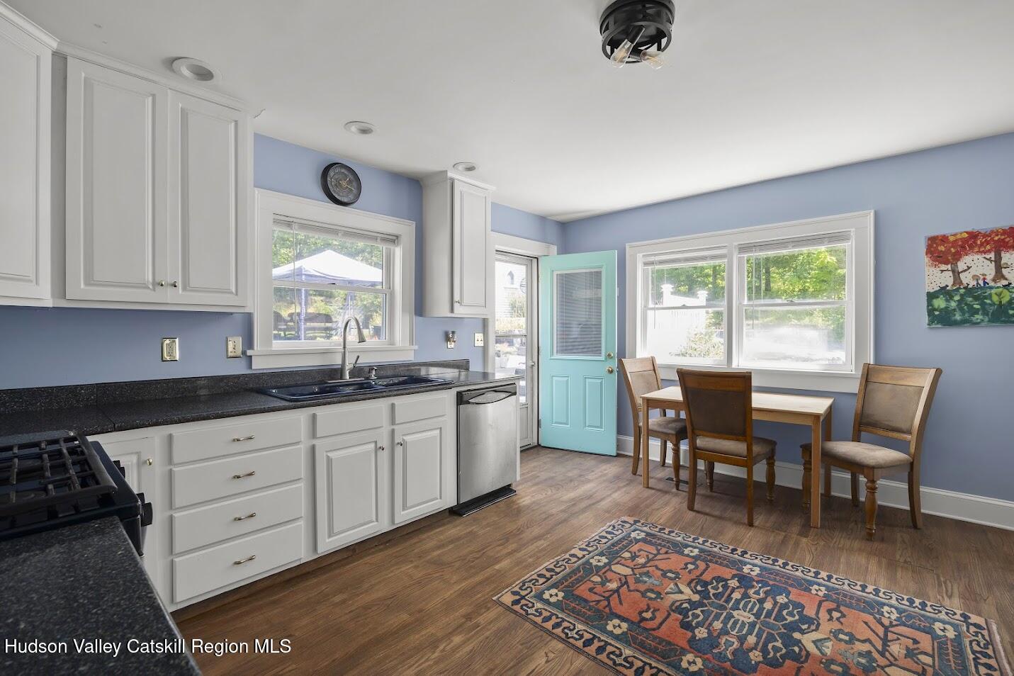 4 Greely Road Craryville, NY 12521 - Photo 7 of 37 a open kitchen with granite countertop a dining table chairs and white cabinets