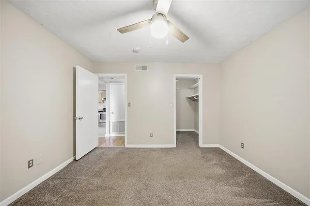a bathroom with a bathtub shower sink mirror vanity and toilet