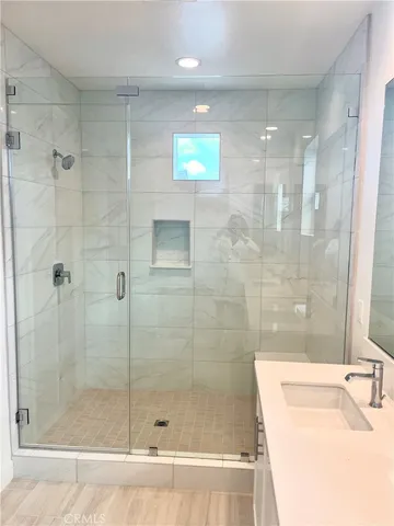 a bathroom with a shower and a sink