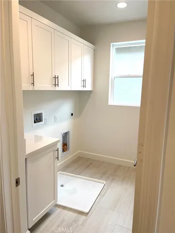 a kitchen with white cabinets and a sink
