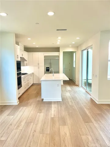 a large room with kitchen view and living room view