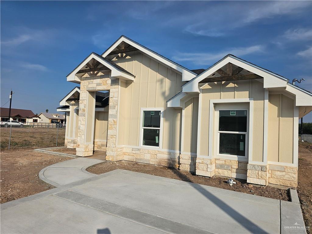 2251 Tuscany Road Weslaco, TX 78596 - Photo 3 of 4 a front view of a house with a yard