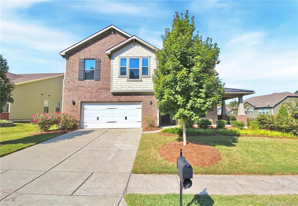 1314 Cilantro Court Tega Cay, SC 29708 - Photo 2 of 48 a front view of a house with a yard and garage