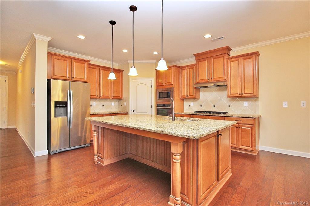1314 Cilantro Court Tega Cay, SC 29708 - Photo 11 of 48 a kitchen with stainless steel appliances granite countertop a sink a stove and a refrigerator