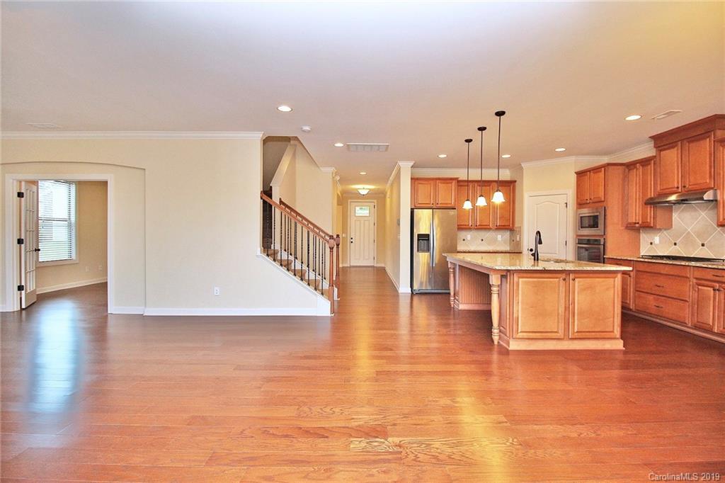 1314 Cilantro Court Tega Cay, SC 29708 - Photo 17 of 48 a view of kitchen with kitchen island a sink wooden floor and view living room