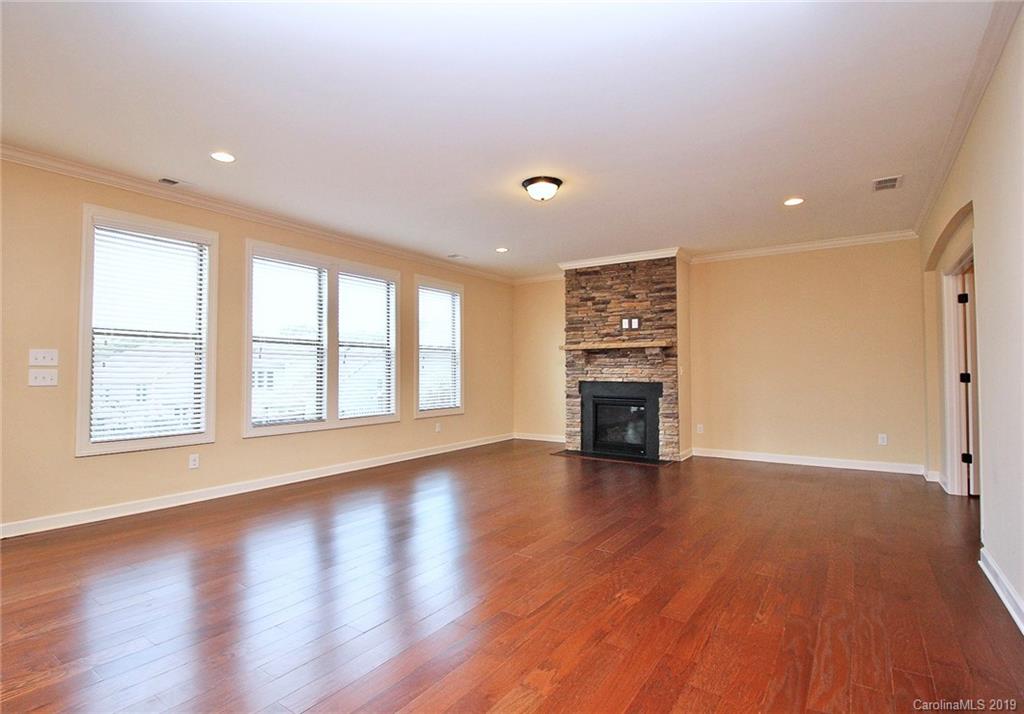 1314 Cilantro Court Tega Cay, SC 29708 - Photo 19 of 48 a view of an empty room with a window and wooden floor