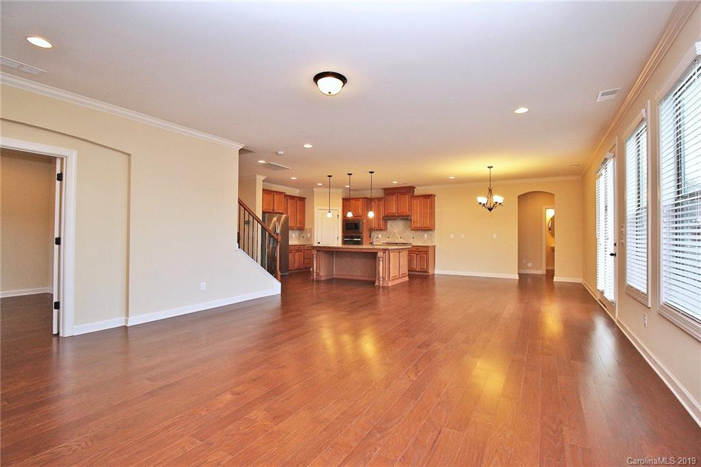 1314 Cilantro Court Tega Cay, SC 29708 - Photo 20 of 48 a view of a living room a kitchen with a sink and a large window