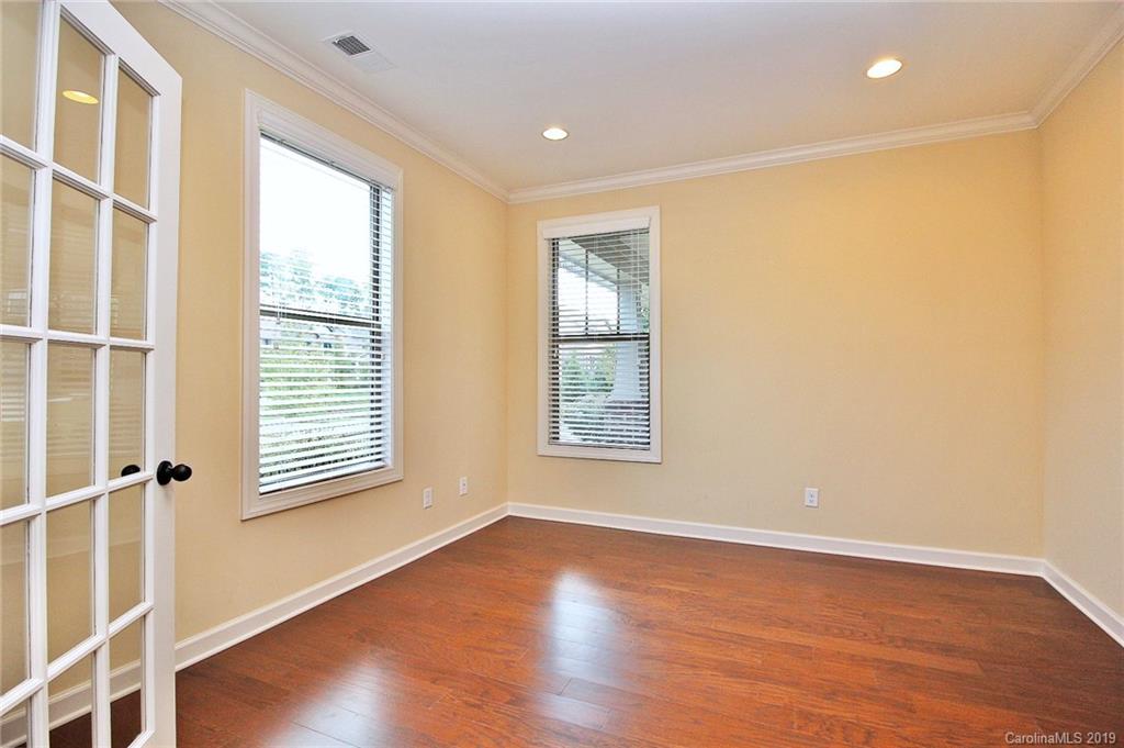 1314 Cilantro Court Tega Cay, SC 29708 - Photo 21 of 48 an empty room with wooden floor and windows