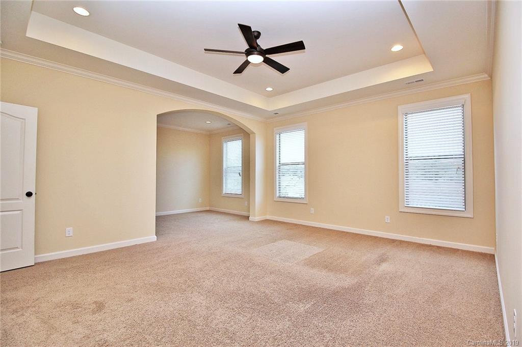 1314 Cilantro Court Tega Cay, SC 29708 - Photo 24 of 48 an empty room with windows and ceiling fan