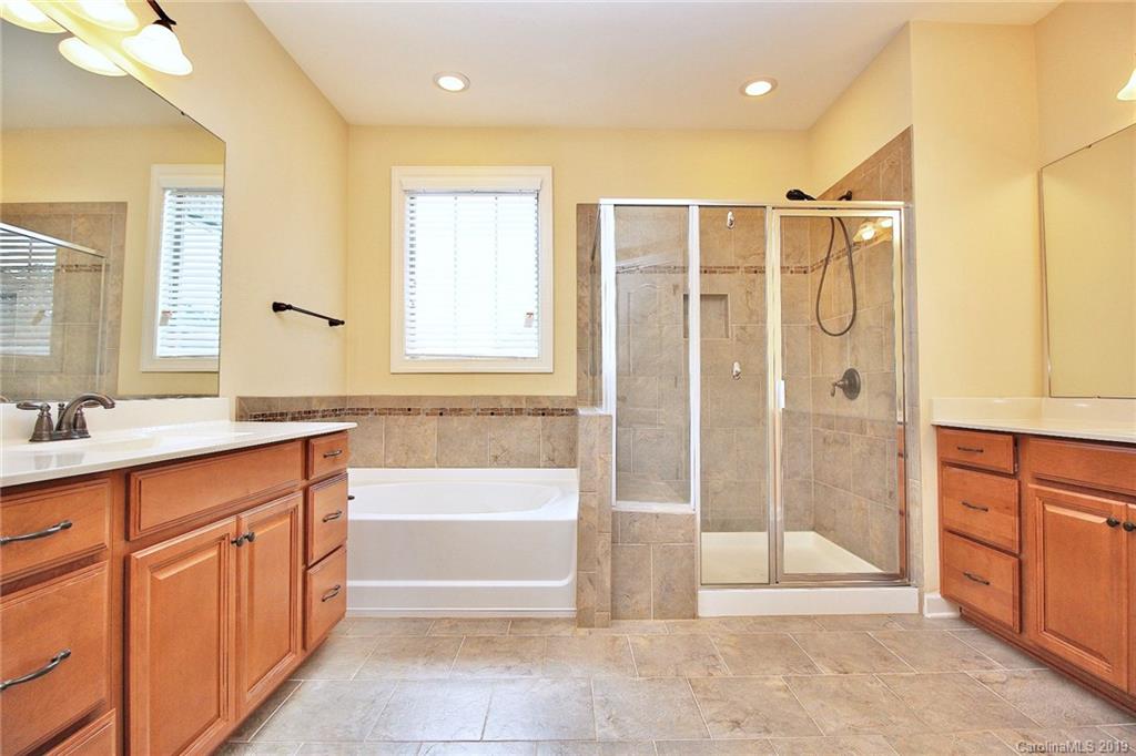 1314 Cilantro Court Tega Cay, SC 29708 - Photo 27 of 48 a spacious bathroom with a tub shower sink and mirror