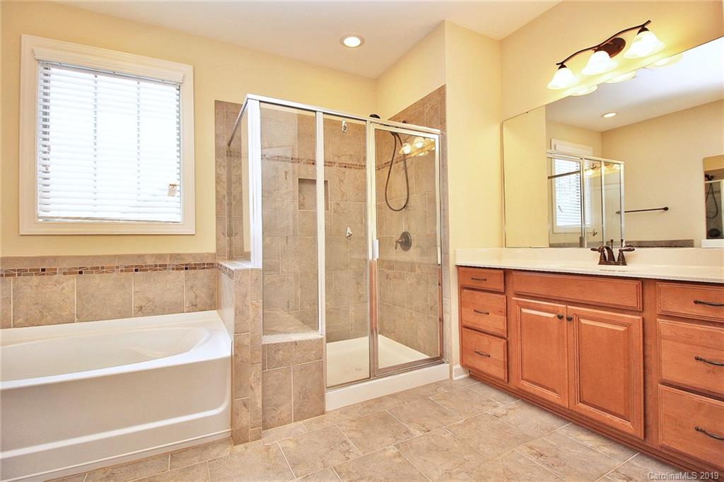 1314 Cilantro Court Tega Cay, SC 29708 - Photo 28 of 48 a spacious bathroom with a tub shower and sink