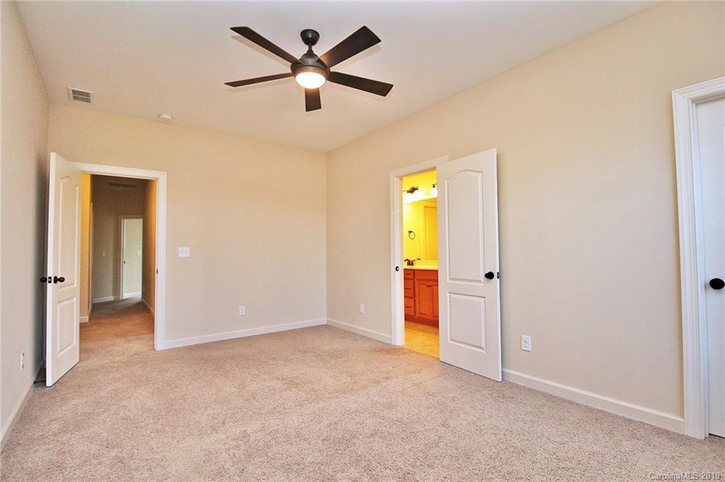 1314 Cilantro Court Tega Cay, SC 29708 - Photo 31 of 48 an empty room with closet and a ceiling fan