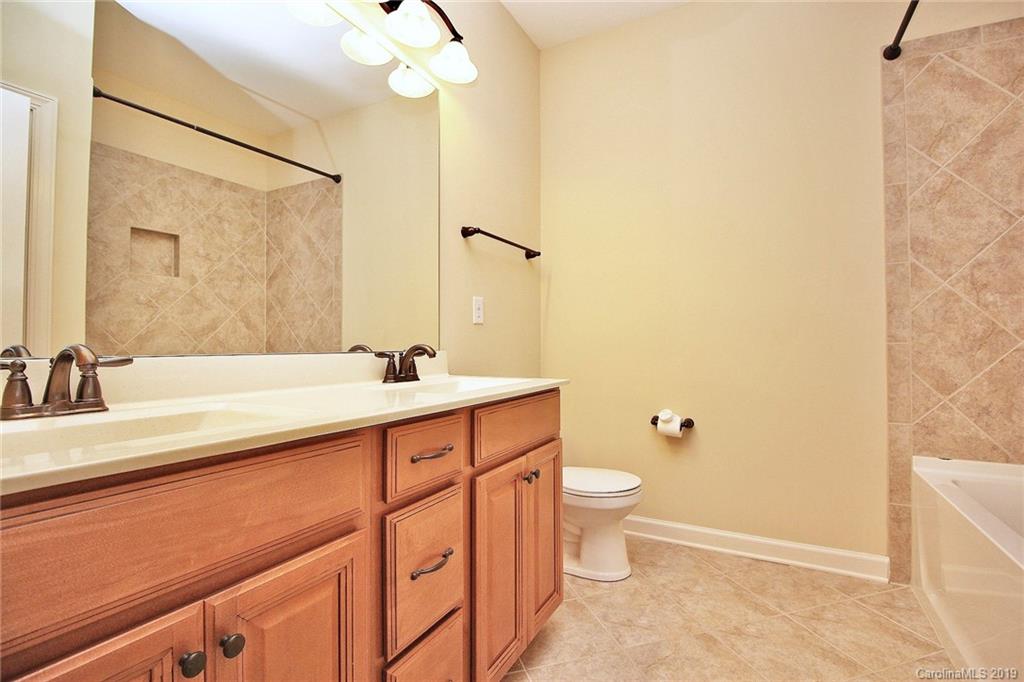 1314 Cilantro Court Tega Cay, SC 29708 - Photo 36 of 48 a bathroom with a double vanity sink toilet and a mirror