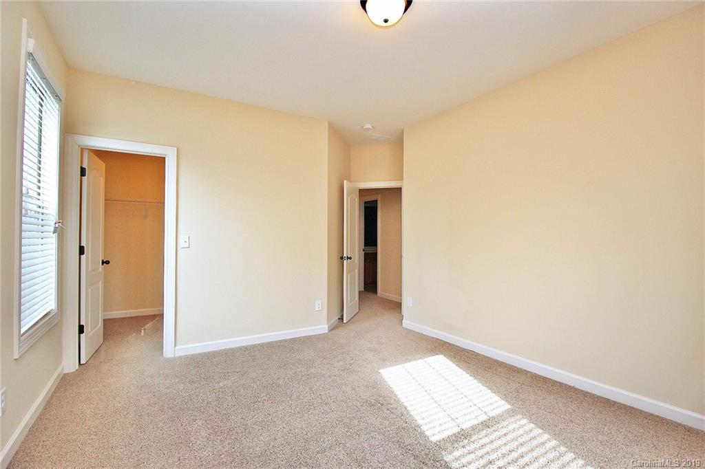 1314 Cilantro Court Tega Cay, SC 29708 - Photo 39 of 48 a view of hallway with a window and a ceiling fan