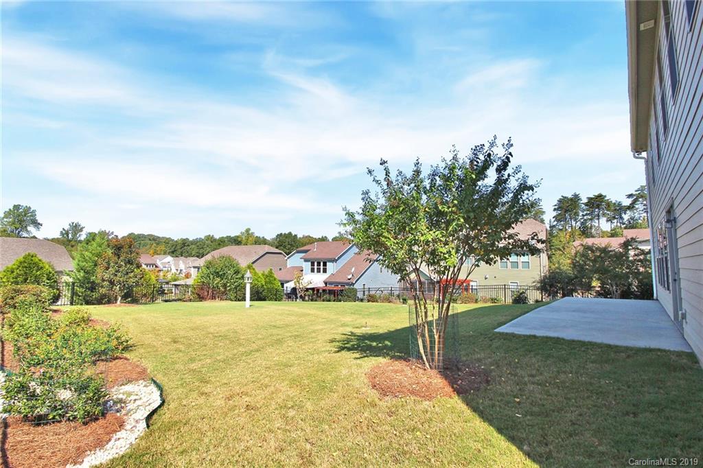 1314 Cilantro Court Tega Cay, SC 29708 - Photo 47 of 48 a view of a garden with a building in the background