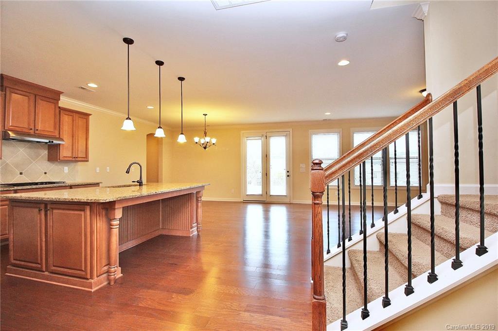 1314 Cilantro Court Tega Cay, SC 29708 - Photo 9 of 48 a open kitchen with stainless steel appliances granite countertop a stove kitchen island hardwood floor and a sink