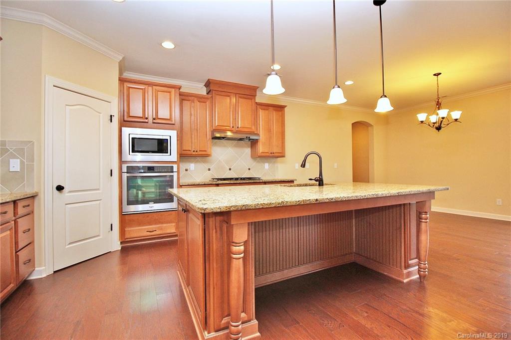 1314 Cilantro Court Tega Cay, SC 29708 - Photo 10 of 48 a view of a kitchen with a sink and dishwasher with wooden floor