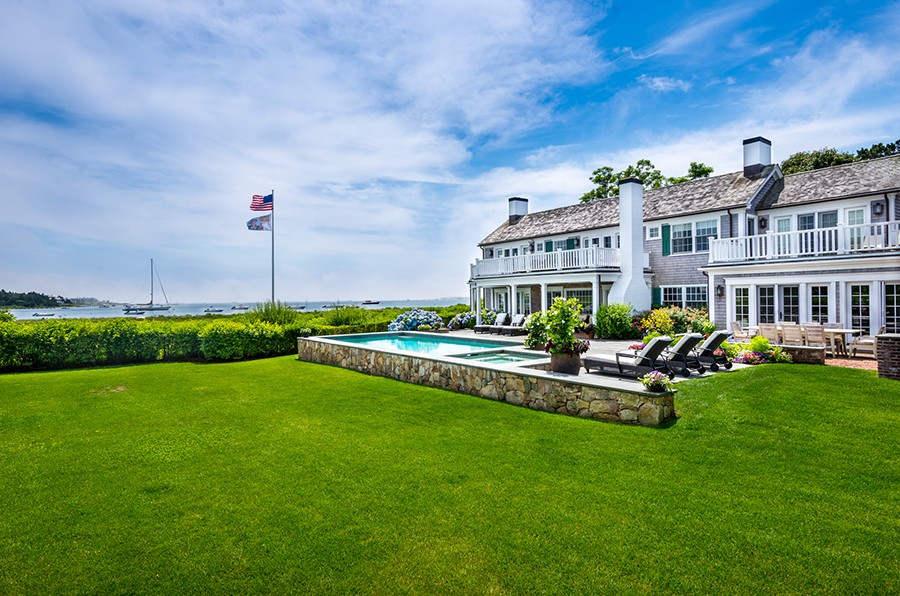 a view of a house with a yard and sitting area