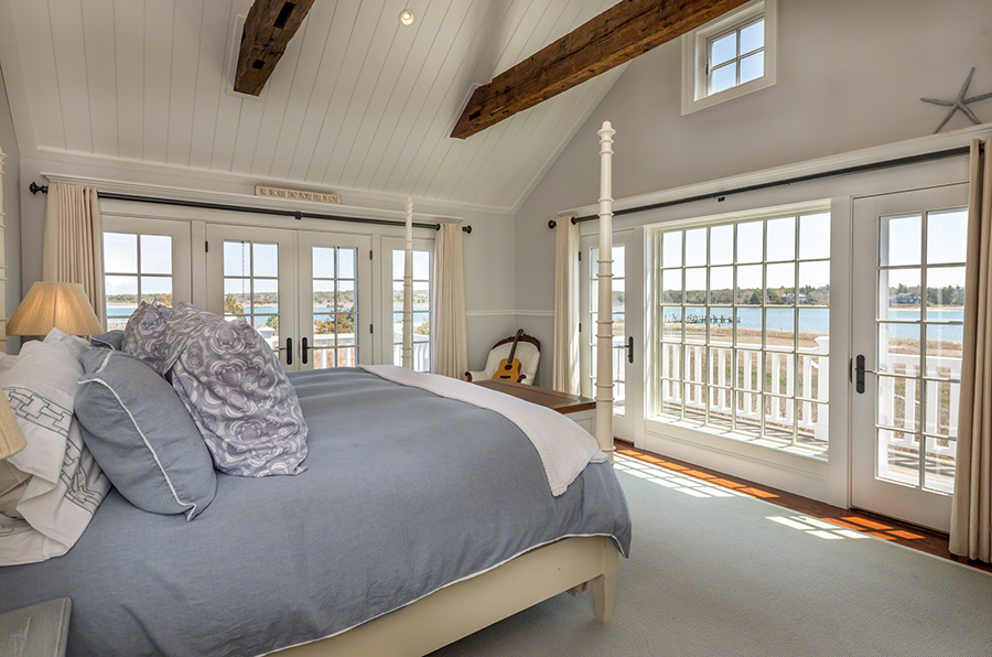 36 Down Harbor Road Edgartown, MA 02539 - Photo 27 of 54 a bed sitting in a bedroom next to a large window