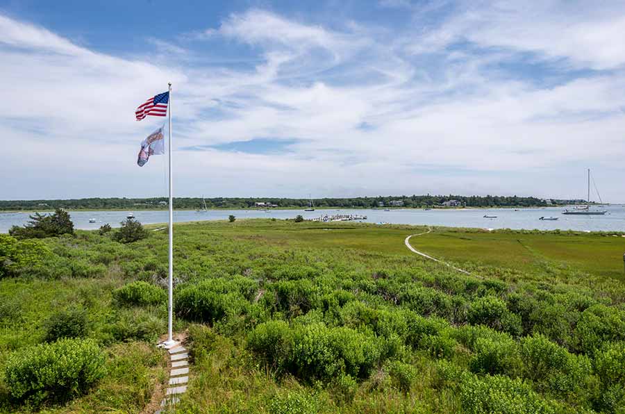 36 Down Harbor Road Edgartown, MA 02539 - Photo 31 of 54 a view of a swimming pool and lake from inside room