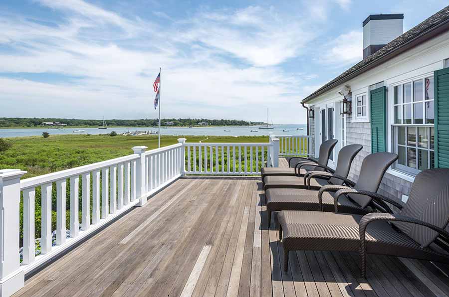 36 Down Harbor Road Edgartown, MA 02539 - Photo 32 of 54 a view of a balcony with two chairs and a wooden floor