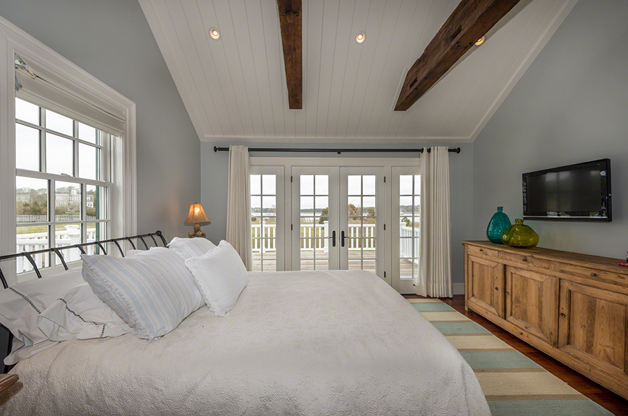 36 Down Harbor Road Edgartown, MA 02539 - Photo 34 of 54 a spacious bedroom with a large bed and a flat tv screen