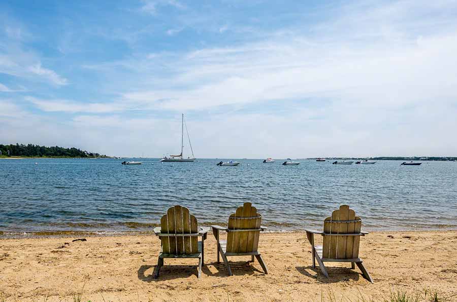 36 Down Harbor Road Edgartown, MA 02539 - Photo 6 of 54 a ocean view with chairs next to a yard