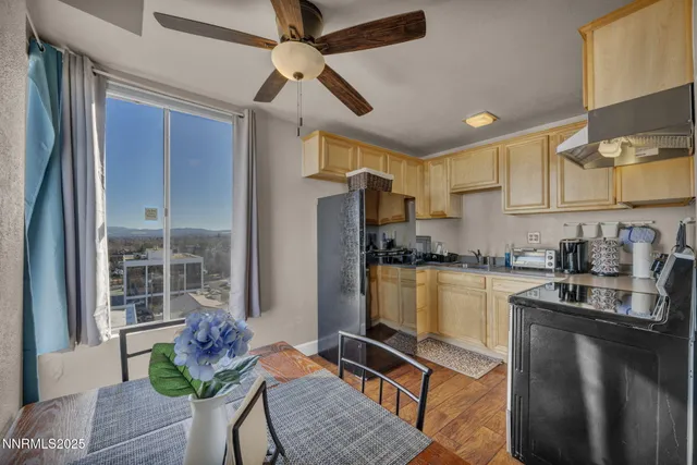 a kitchen with granite countertop a refrigerator stove top oven and sink