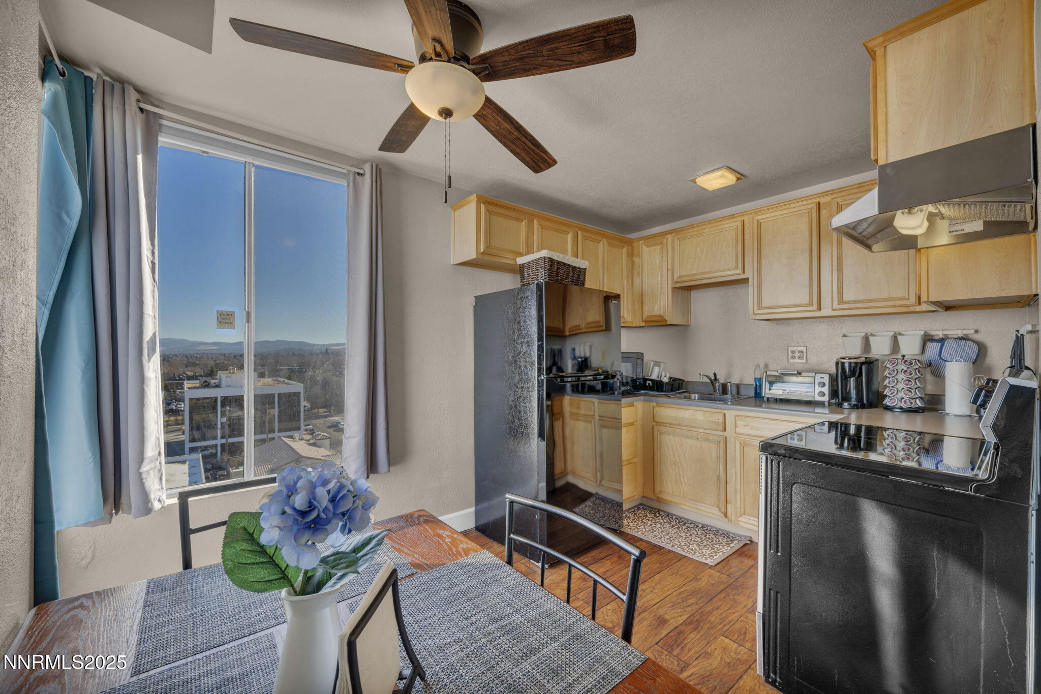 280 Island Avenue, Unit 1406 Reno, NV 89501 - Photo 3 of 28 a kitchen with granite countertop a refrigerator stove top oven and sink