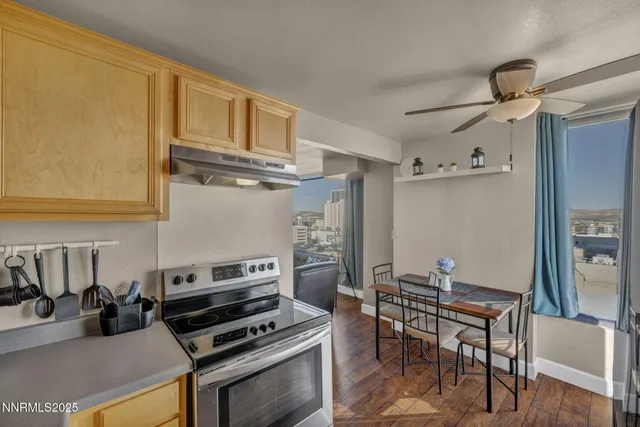 a kitchen with stainless steel appliances kitchen island granite countertop a refrigerator and a stove top oven