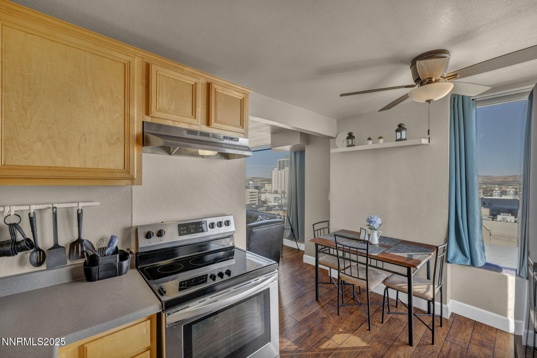 280 Island Avenue, Unit 1406 Reno, NV 89501 - Photo 10 of 28 a kitchen with stainless steel appliances kitchen island granite countertop a refrigerator and a stove top oven