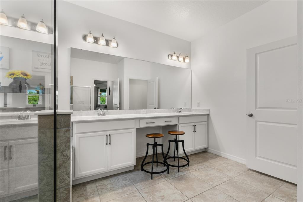 5637 Beggs Road St. Cloud, FL 34771 - Photo 22 of 35 a bathroom with a sink and a mirror