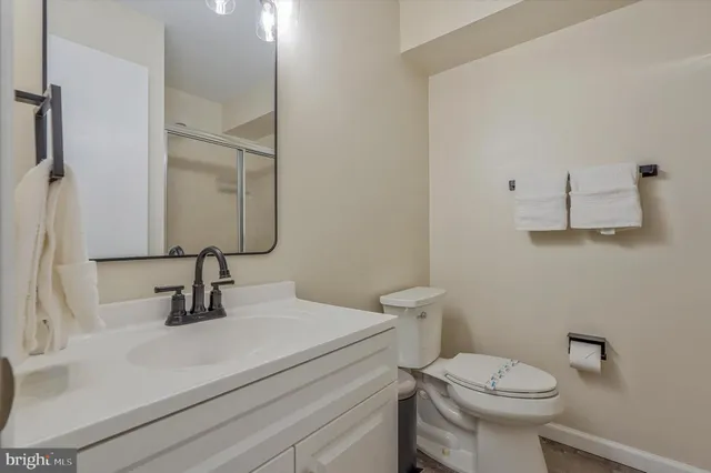 a bathroom with a sink toilet and mirror