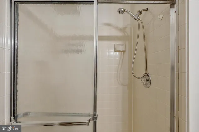 a bathroom with a glass shower door