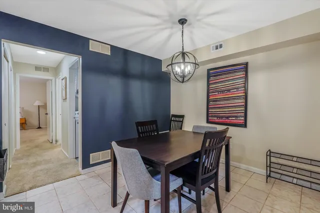 a view of a dining room with a table and chairs