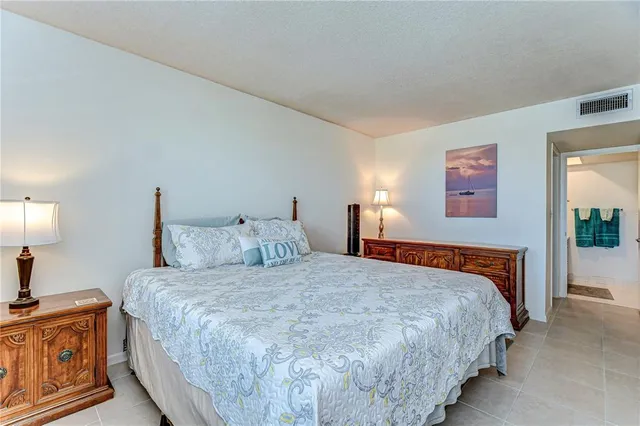 a bedroom with a bed and a lamp on table