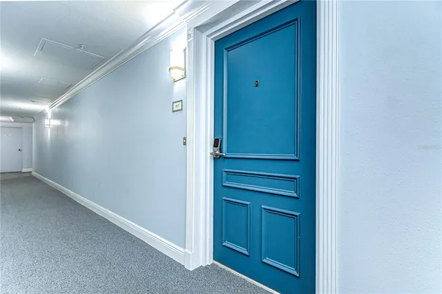 a view of front door with cabinets
