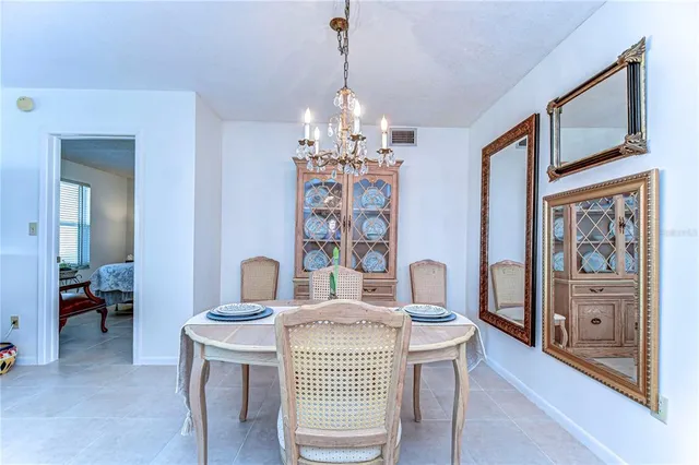 a dining room with furniture and chandelier