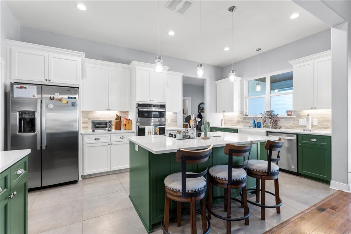 1430 Antioch Road Paige, TX 78659 - Photo 18 of 40 a kitchen with sink a refrigerator and chairs