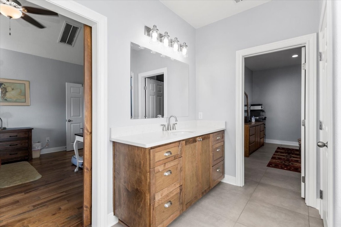1430 Antioch Road Paige, TX 78659 - Photo 27 of 40 a spacious bathroom with a double vanity sink and a mirror
