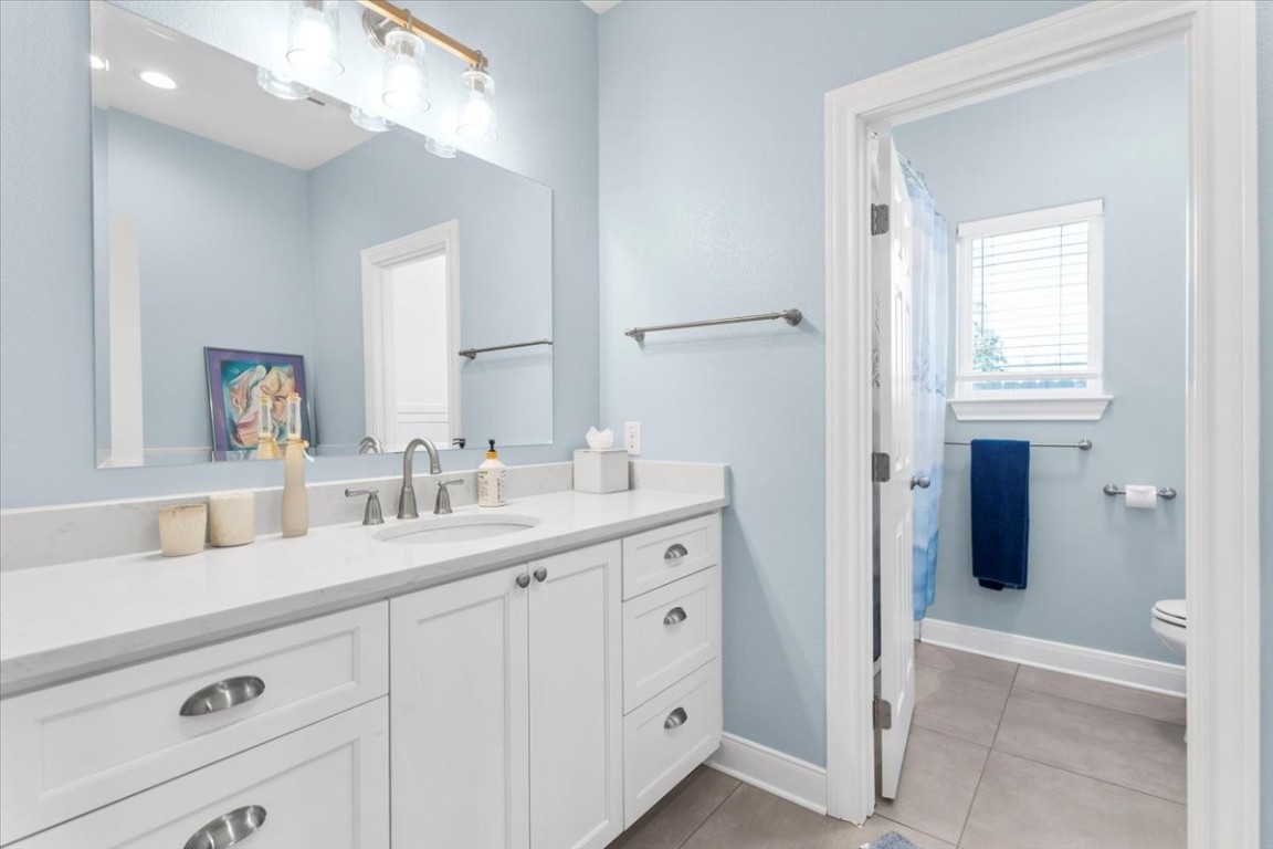 1430 Antioch Road Paige, TX 78659 - Photo 30 of 40 a bathroom with a double vanity sink and mirror