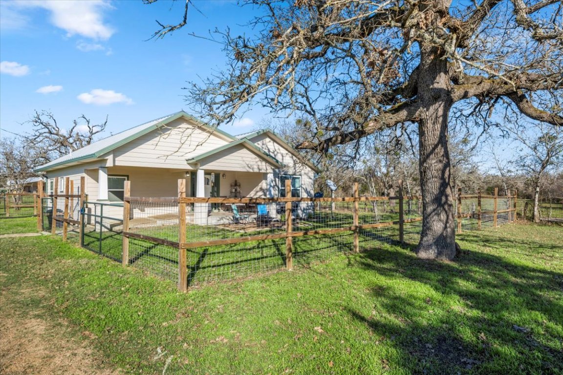 1430 Antioch Road Paige, TX 78659 - Photo 35 of 40 a view of a house with backyard and sitting area