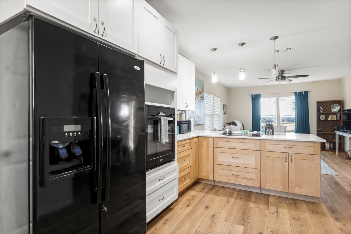 1430 Antioch Road Paige, TX 78659 - Photo 39 of 40 a kitchen with stainless steel appliances a refrigerator sink and cabinets