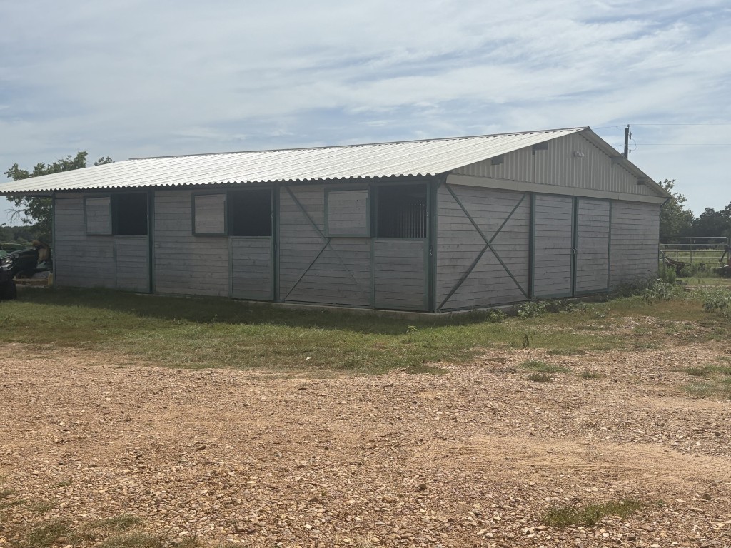 1430 Antioch Road Paige, TX 78659 - Photo 4 of 40 "CastleBrook" Stables side view of 3 stalls with exterior doors